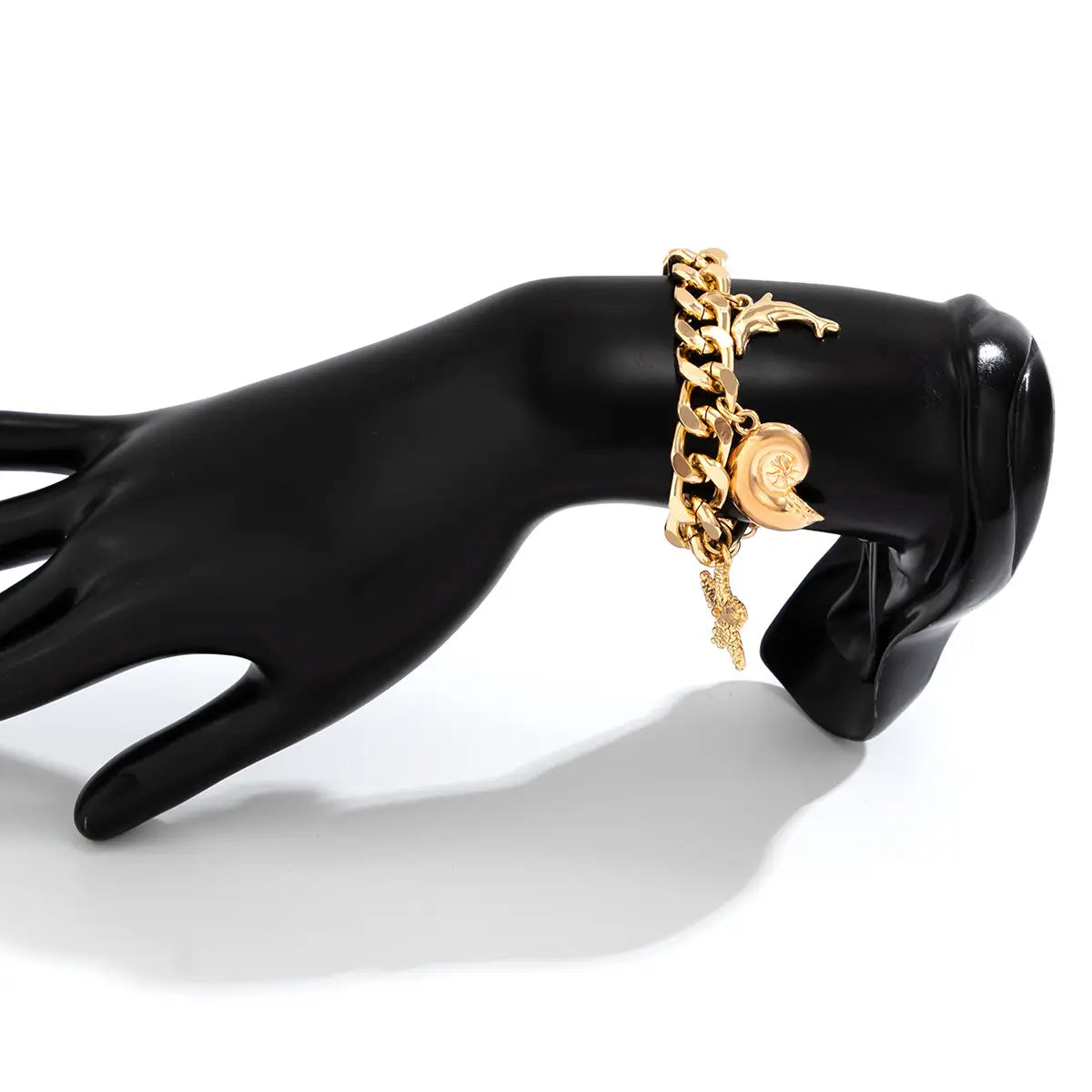 Gold-toned chain bracelet set featuring intricate conch dolphin and circular charm details from the boho conch dolphin starfish choker necklace bracelet set.