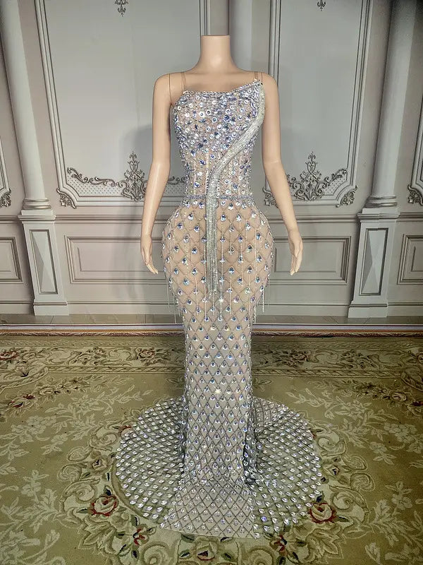 A shimmering silver beaded sexy elegant fishtail gown with a one-shoulder design and intricate diamond-like embellishments cascading down the bodice and skirt.