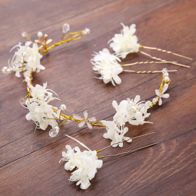A delicate white floral handmade wreath headwear adorned with gold wire and clear crystal accents.