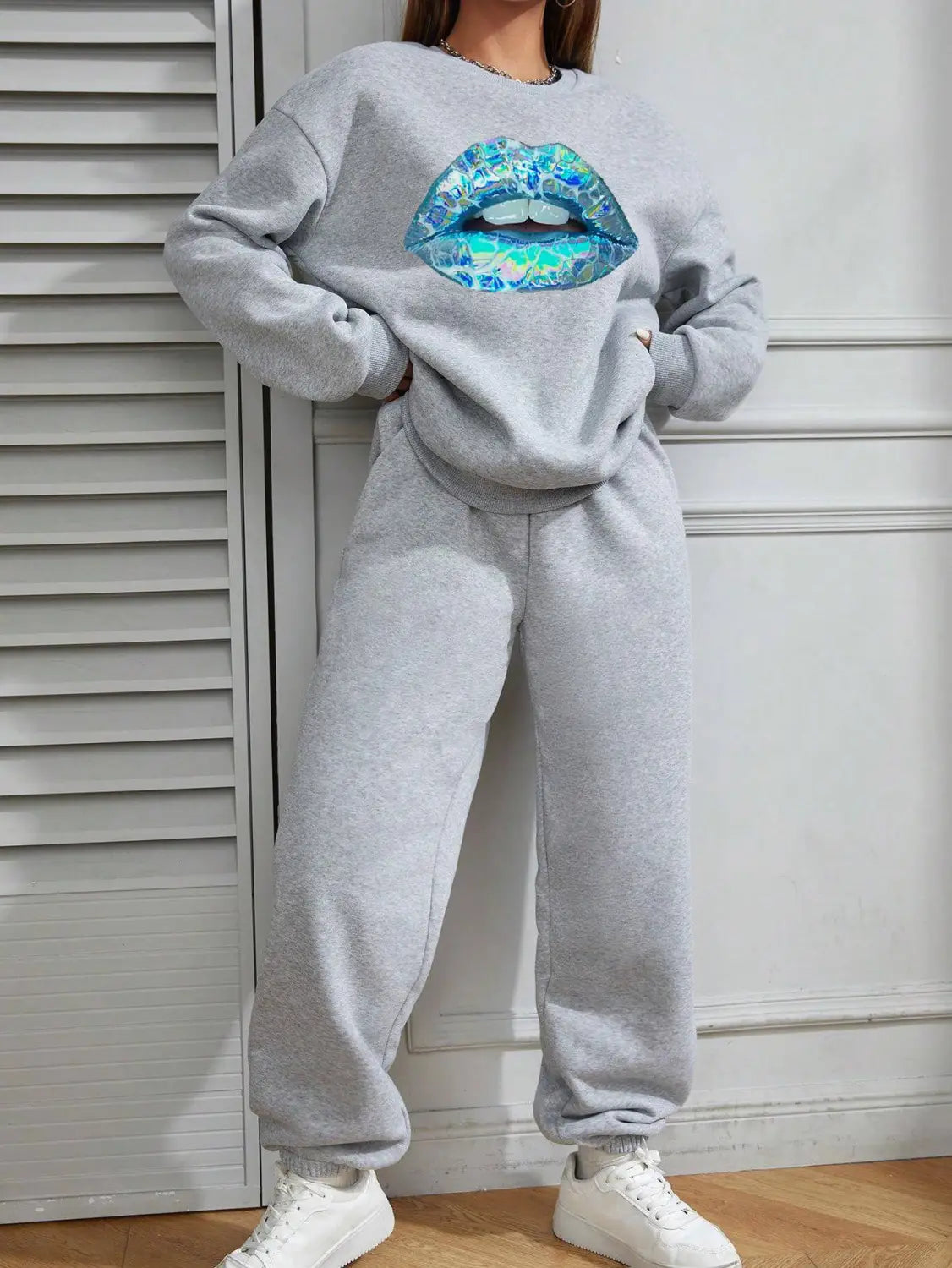 Gray women’s crew neck long sleeve sweatshirt featuring a large shiny blue and teal lips graphic on the front.