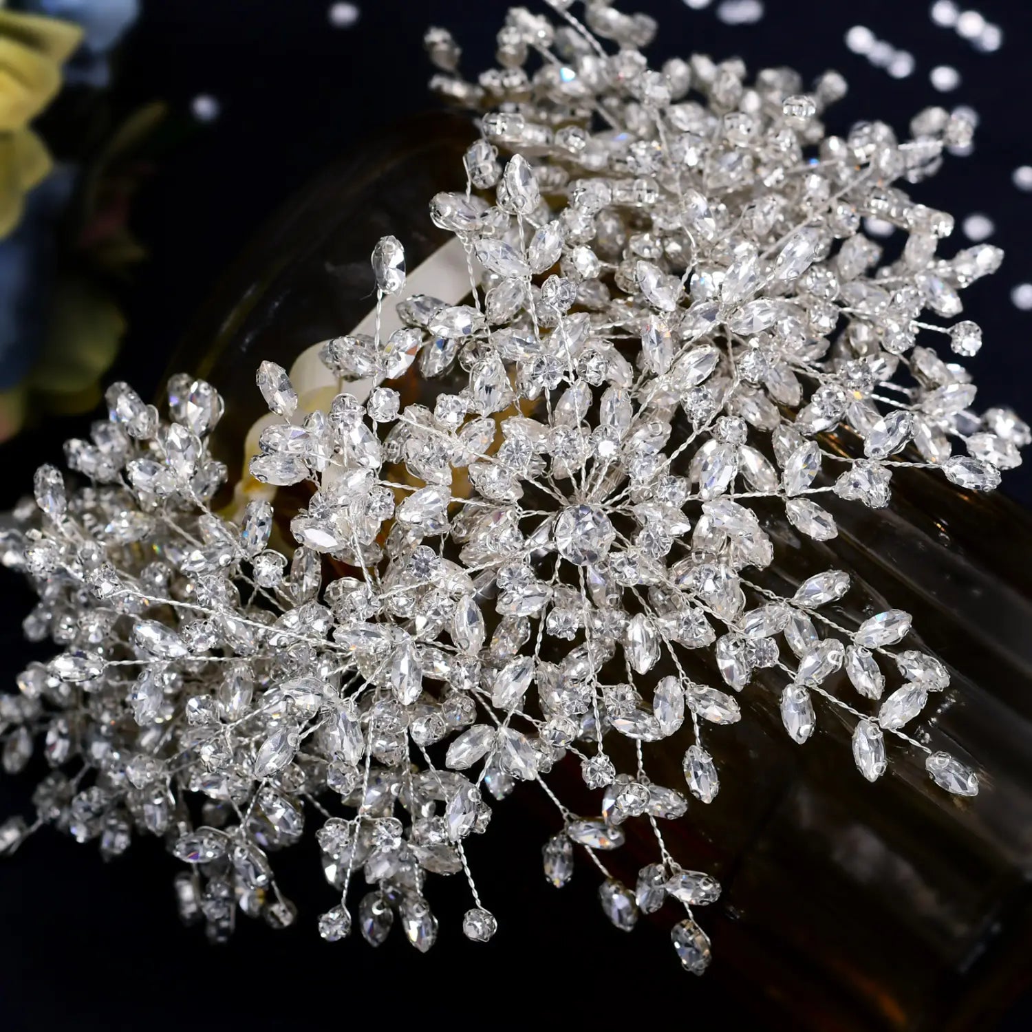 heavy handmade rhinestone silver crystal hair accessory designed as a delicate branch of leaves and blossoms for a snow queen wedding crown