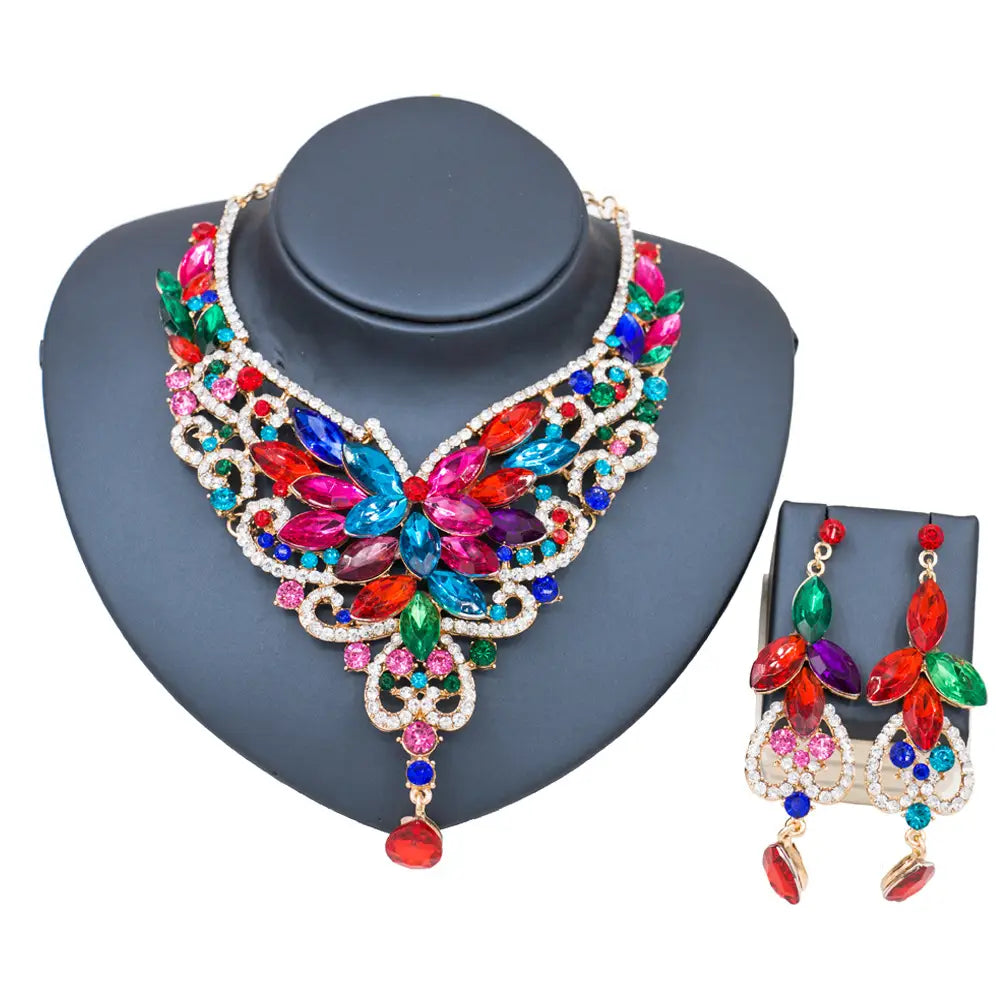 Vibrant multicolored gemstone necklace with intricate gold-tone filigree and matching earrings featuring a bold floral design in the american color exaggerated bride jewelry set for a color exaggerated bride look.