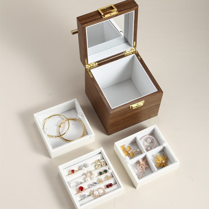 Classical wooden jewelry box with gold-tone hardware and a mirrored velvet interior