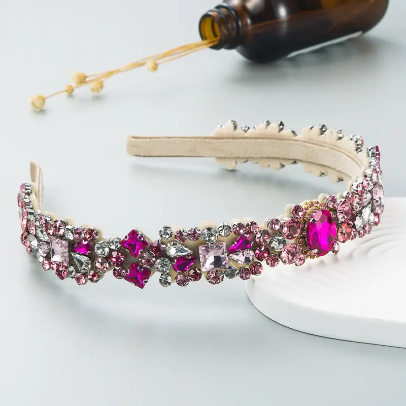 Baroque vintage court style headband featuring sparkling pink and silver rhinestones on a cream-colored velvet band.