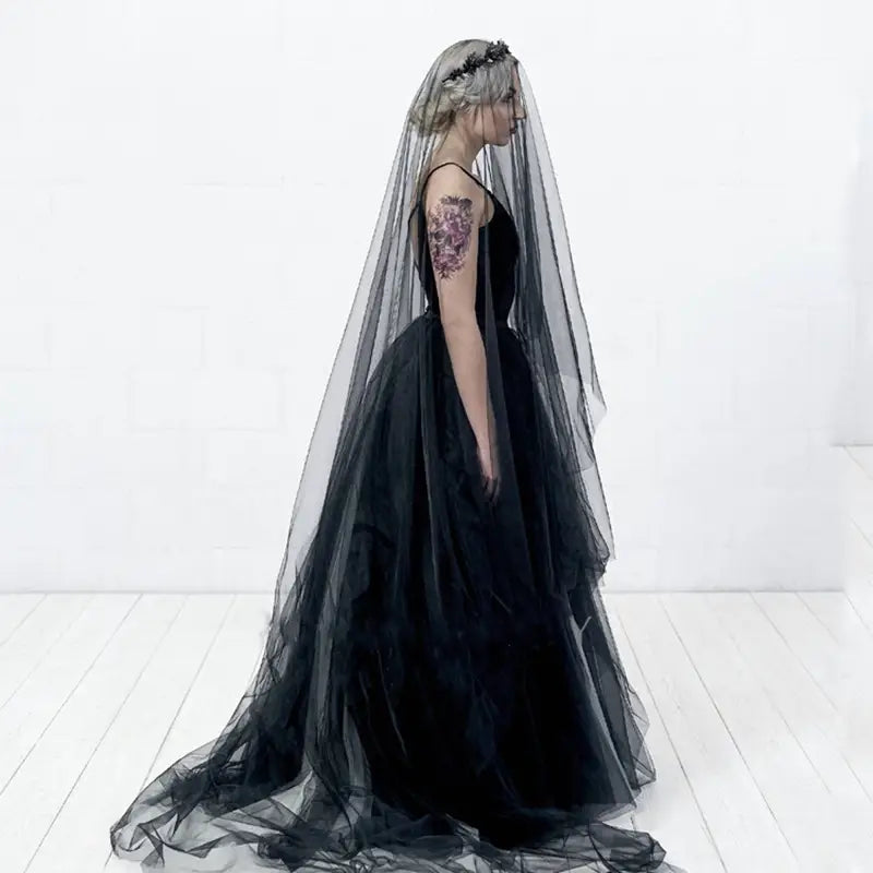Elegant bride wedding black veil made of sheer black tulle with delicate floral embellishments adorning the headpiece.
