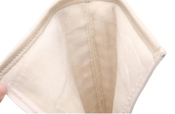 beige mesh face mask with reinforced stitching and elastic ear loops displayed alongside fashion white platform lace up high boots