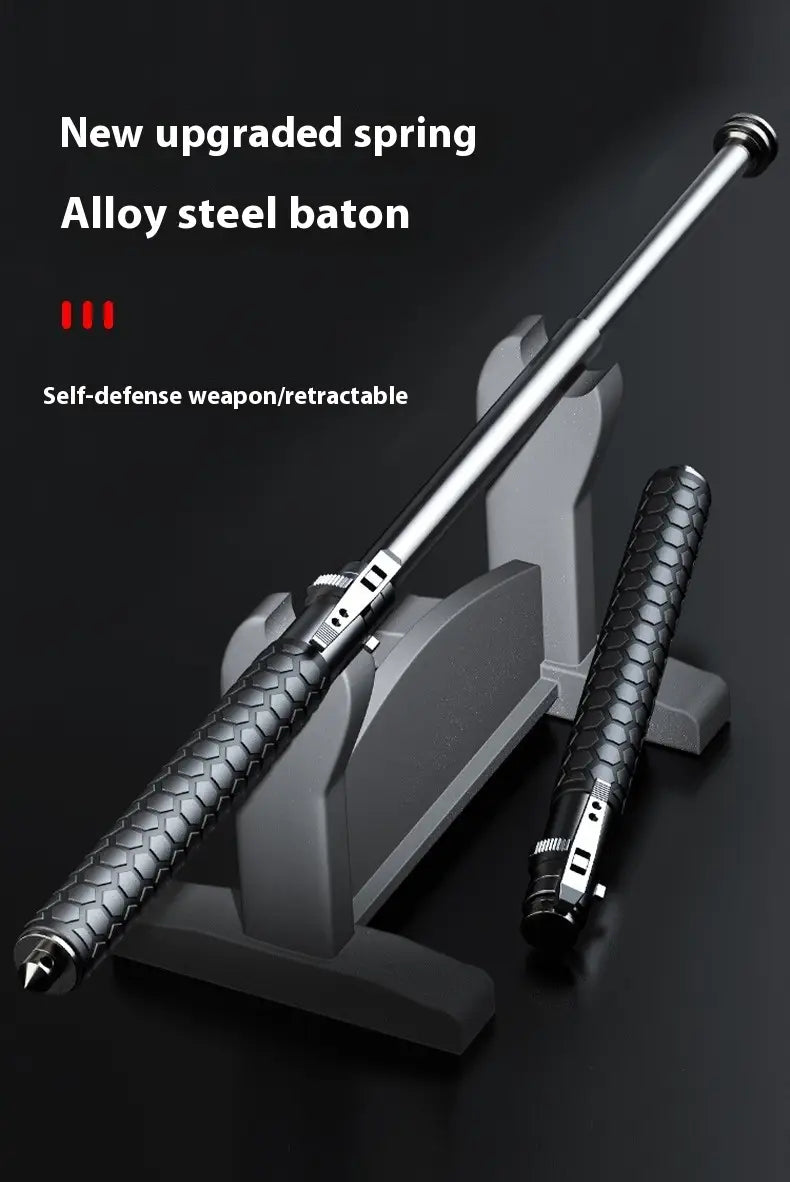 Silver aluminium alloy automatic spring self-defense baton with a textured black grip and hexagonal pattern designed for personal protection.