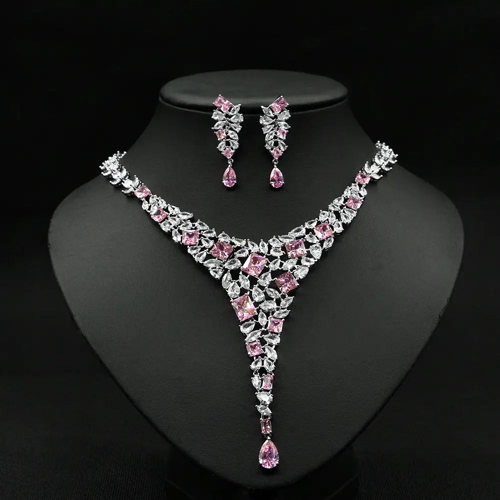 Elegant pink and clear crystal necklace set featuring a v-shaped design with square-cut and teardrop-shaped stones on silver-toned metal, a colorful zircon necklace set perfect for formal occasions.