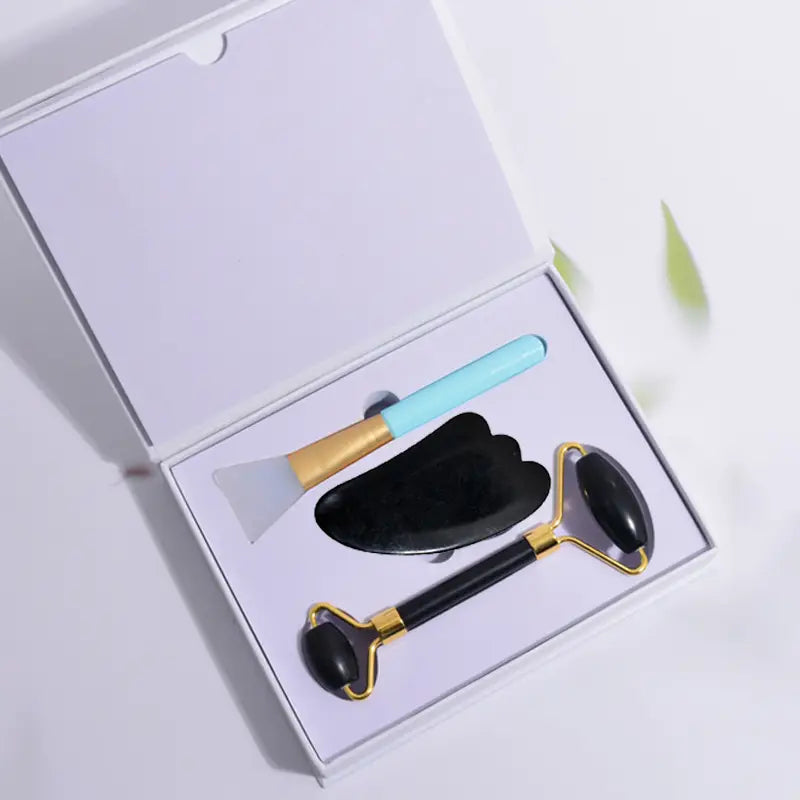 black obsidian beauty face care massage jade roller with a smooth polished black and gold stone surface for face care massage use