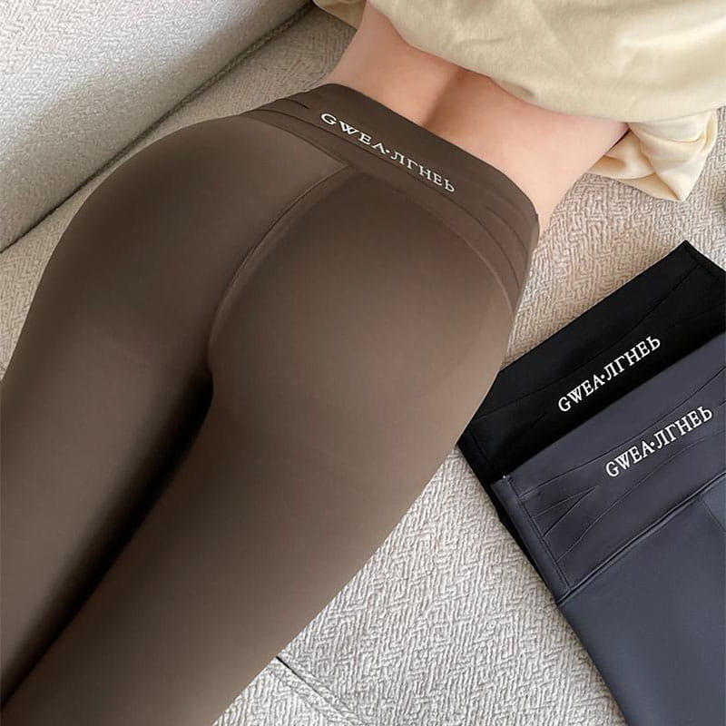 brown fleece thickened winter shark pants high waist leggings with a smooth texture and a subtle elastic waistband featuring the brand name gwea.ltneb in white lettering