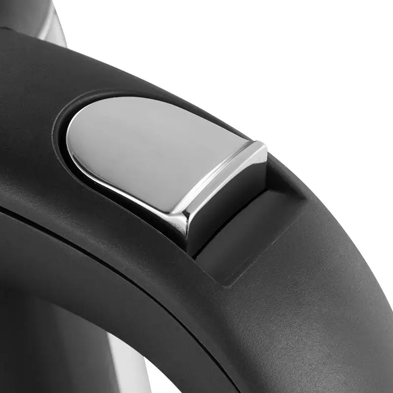 Black plastic kettle handle with a sleek metallic silver button on a small glass electric kettle with red LED light