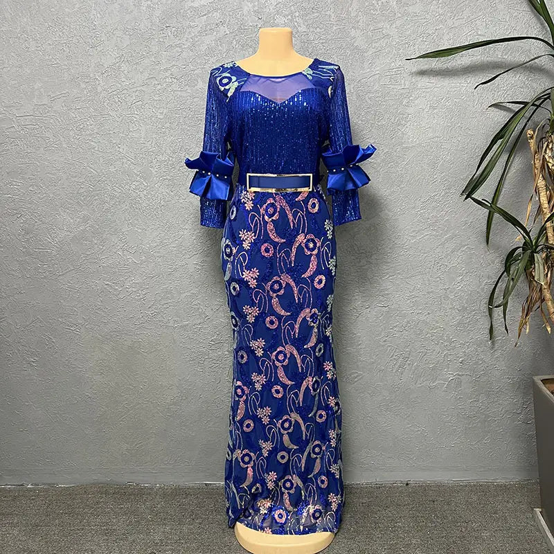 A royal blue half sleeve slim round neck evening dress featuring a sequined bodice, floral embroidery in pink and silver on the skirt, and matching satin bows at the cuffs.