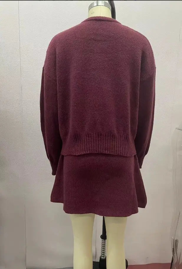 Maroon long sleeve knit sweater dress with ribbed hem and cuffs displayed on a mannequin as part of sweater skirt sets pieces knit casual collection.