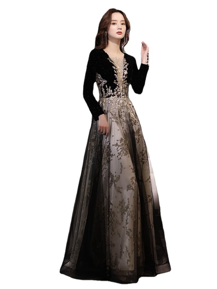 Elegant black moderator long sleeve annual party dress featuring a velvet bodice with intricate gold beading and a sheer layered skirt.