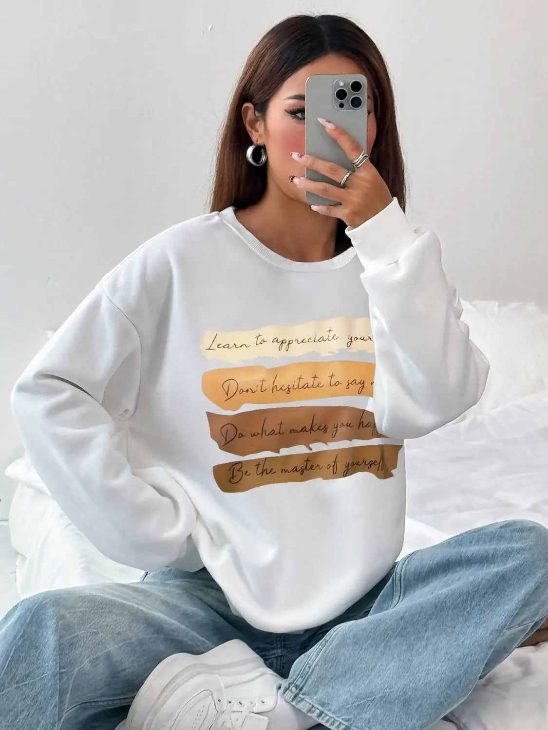 White oversized long sleeve sweatshirt in solid colour featuring motivational quotes on horizontal beige and tan stripes ideal for daily wear.