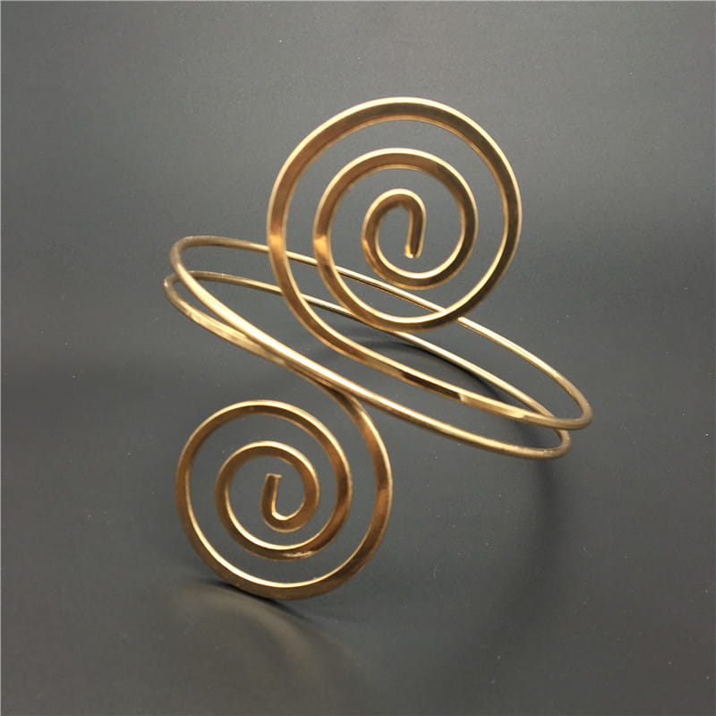 Gold-toned minimalist spiral arm ring jewelry featuring a sleek intertwined wire design as arm ring jewelry.