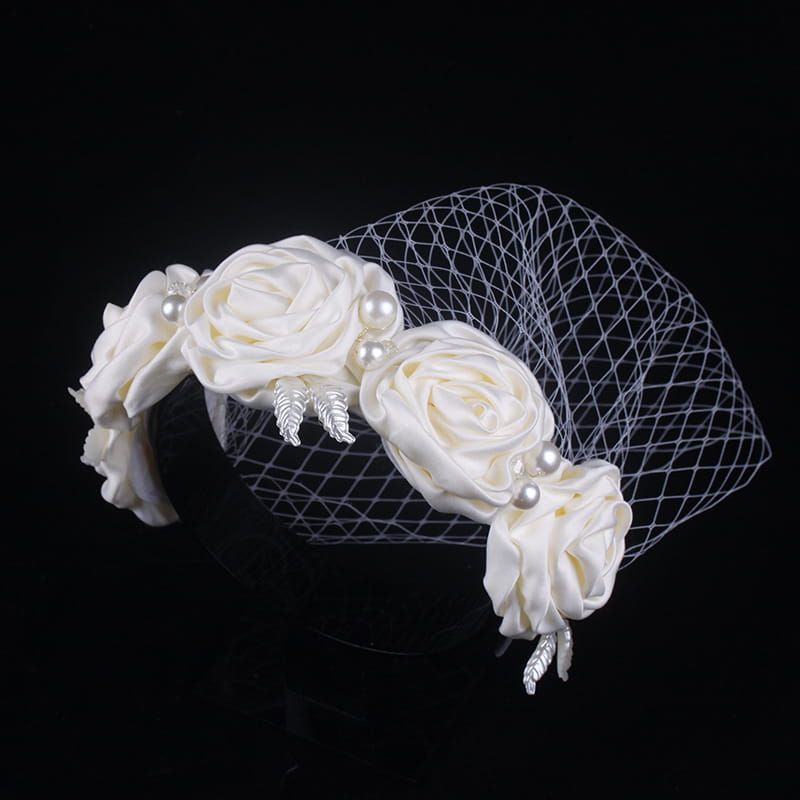 Elegant ivory satin rose hair hoop headdress adorned with pearls and silver leaf accents featuring a delicate mesh veil for a wedding dress.