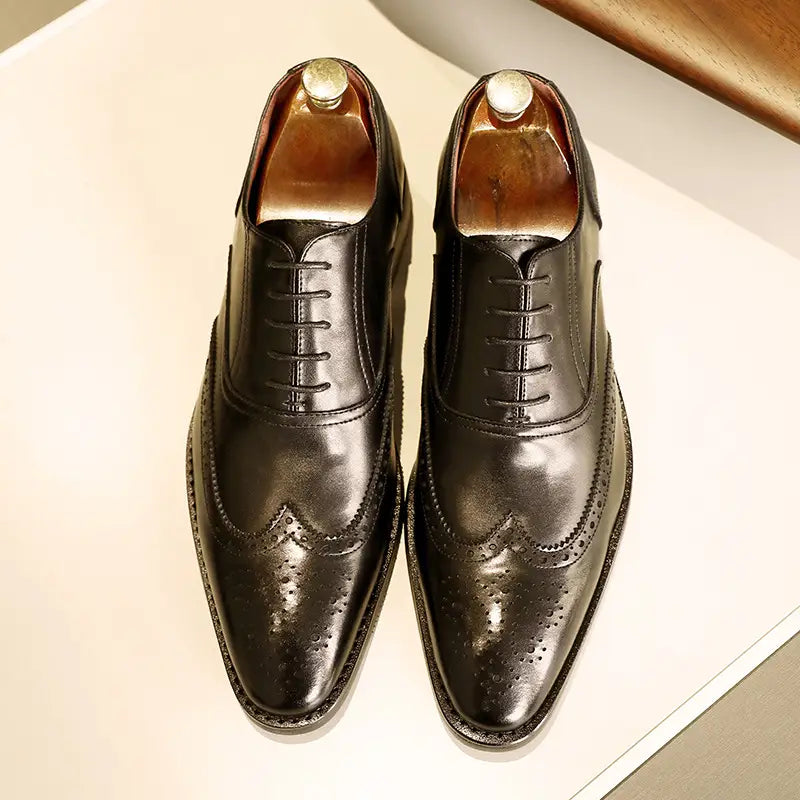 Men black leather shoes brogues with polished finish decorative perforations and rubber sole.