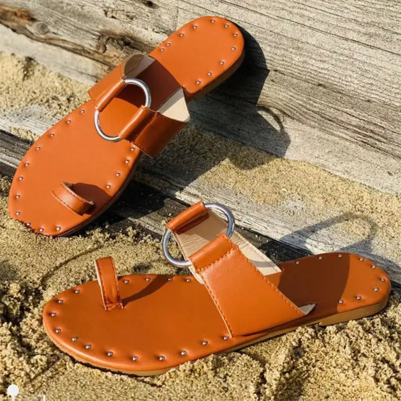 Orange leather casual beach sandals featuring tan leather thong design with silver-toned metal rings and decorative studs ideal for daily casual beach wear and slippers women fashion.