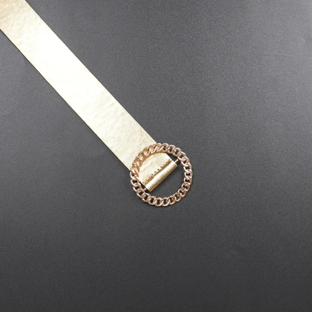 gold-toned chain-link belt buckle with a metallic textured strap on a luxury rhinestone beaded black peplum formal dress