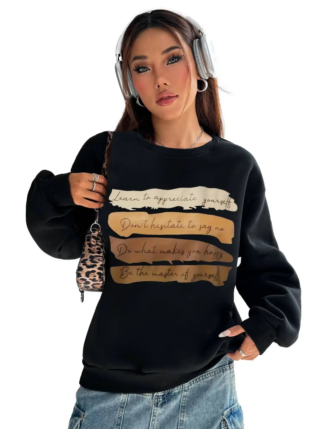 Black long sleeve sweatshirt with gold and beige text on the front designed for daily wear in a solid colour style.