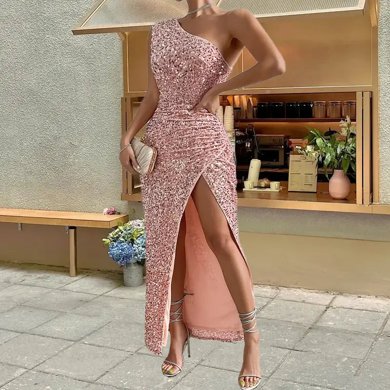 a shimmering pink sequined one-shoulder gown with a high slit and delicate lace-up heels showcasing the sexy sequined shoulder sleeping beauty style