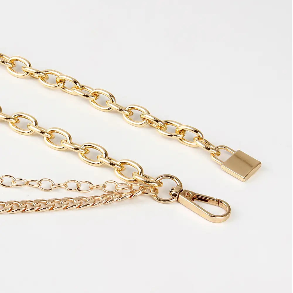 gold-toned chain strap with padlock clasp and carabiner hook as part of silver chain belt summer body jewelry for jewelry hip hop and body jewelry hip use
