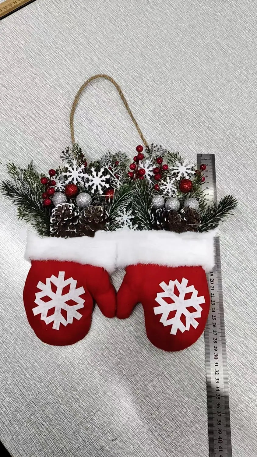 red felt mittens with white snowflake appliqués and faux fur trim filled with festive greenery pinecones red berries and silver ornaments in a christmas garland creative glove shaped wreath.