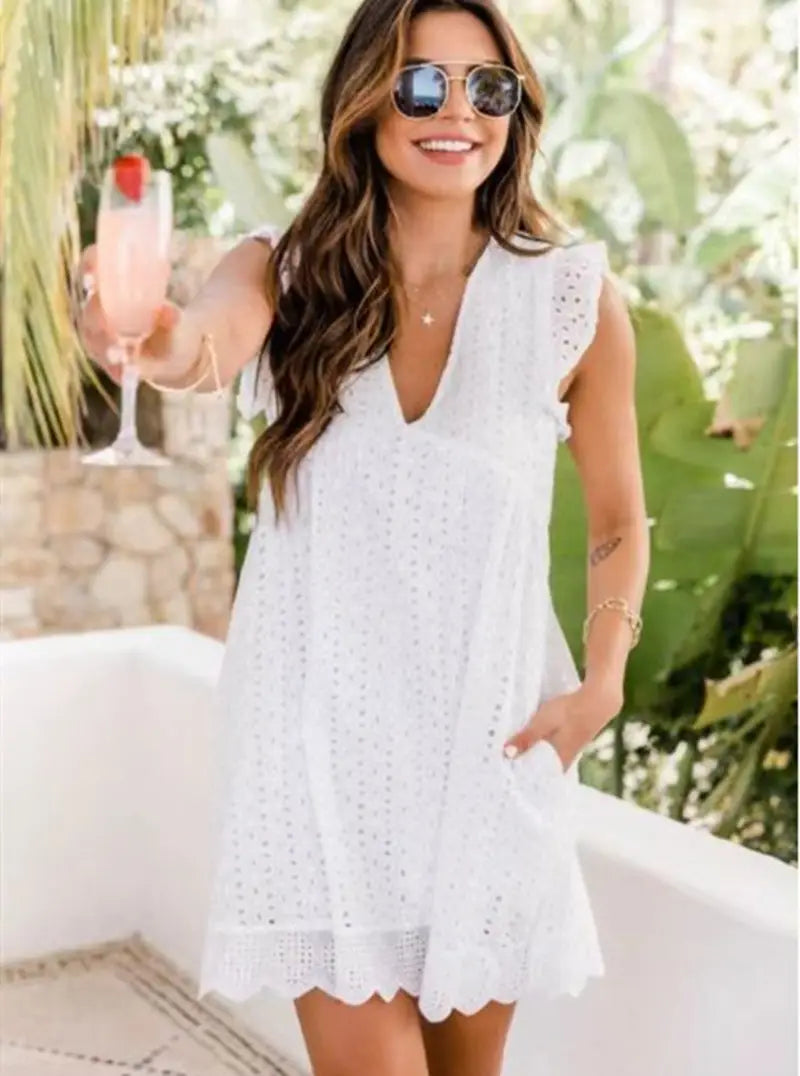 White eyelet lace pocket summer sleeveless dress with scalloped hem and ruffled sleeves for a breezy summer look.