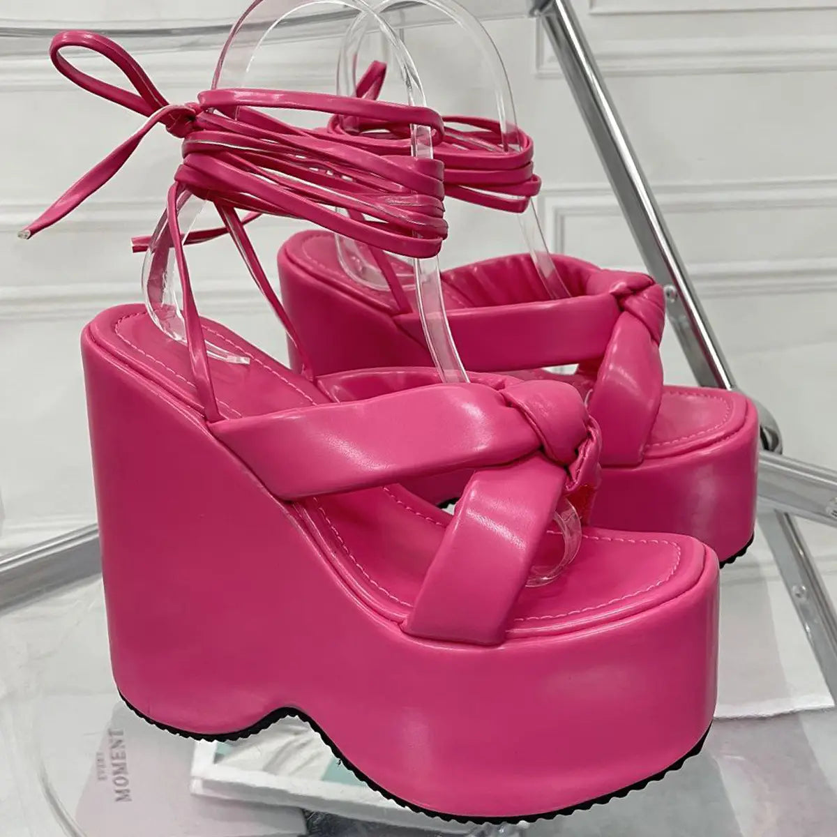 vibrant pink platform wedge high heel sandals featuring glossy faux leather straps and clear plastic ankle ties