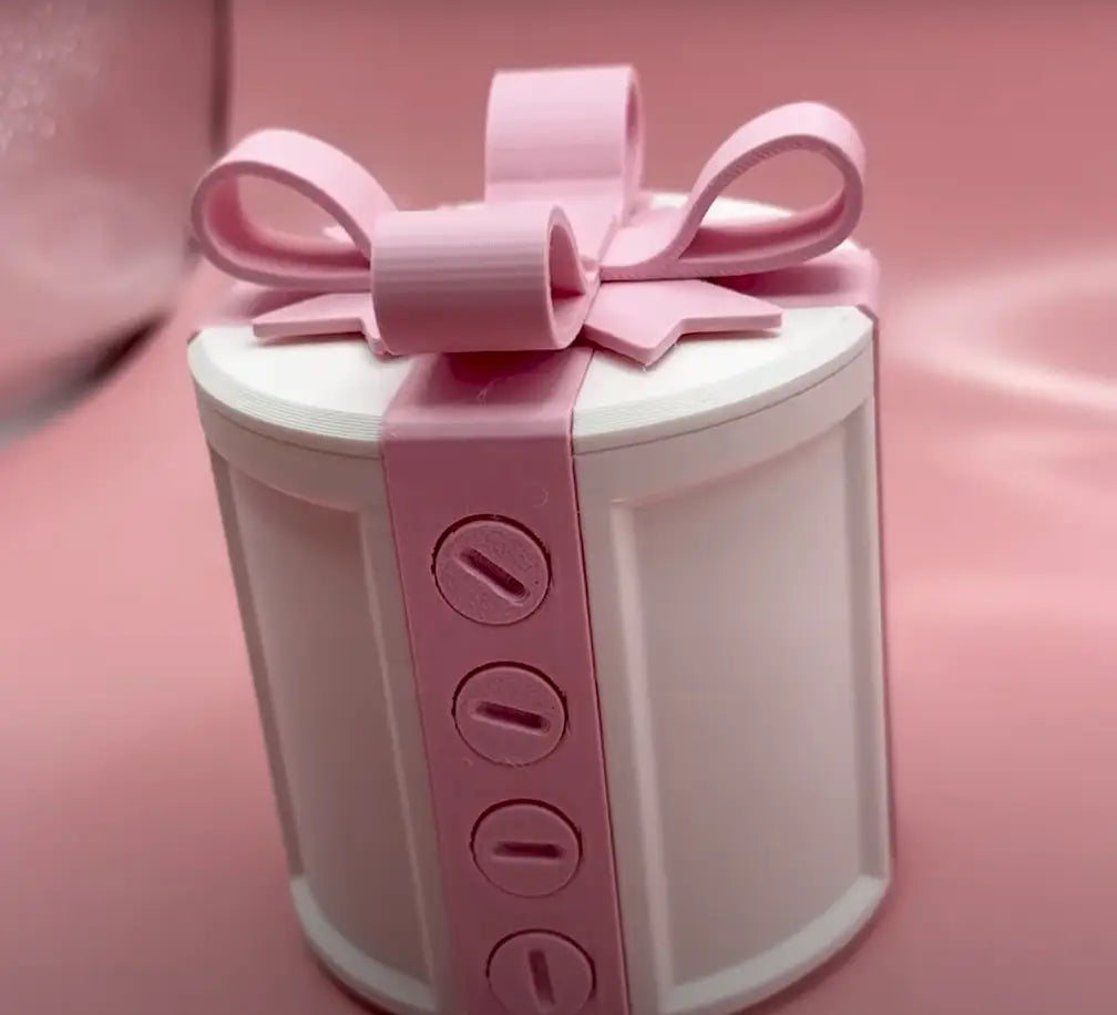 a white cylindrical gift box with a pink ribbon bow and four circular cutouts along its side designed as a creative bowknot pink and white valentine day gift box
