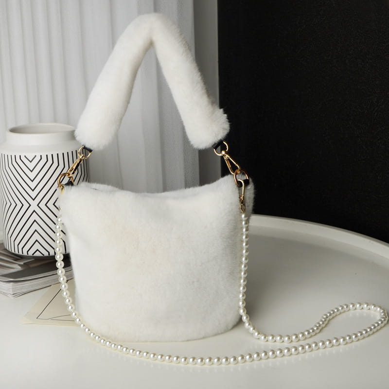 White faux fur plush bucket bag with a fluffy handle and yellow checkerboard plush bucket design featuring a pearl chain design strap.