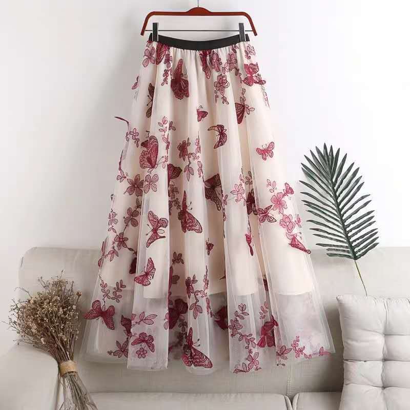 A mid-length sheer white lace mesh skirt featuring embroidered bow lace with intricate red butterfly and floral embroidery.