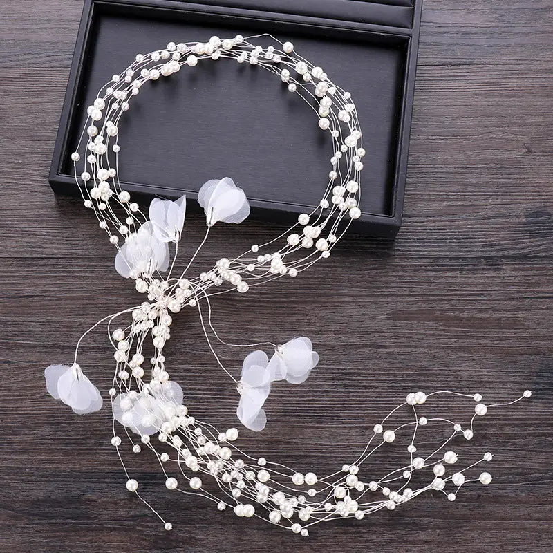 Delicate white floral bridal headdress handmade with tiny pearls and translucent flower petals for a pearl fairy look.