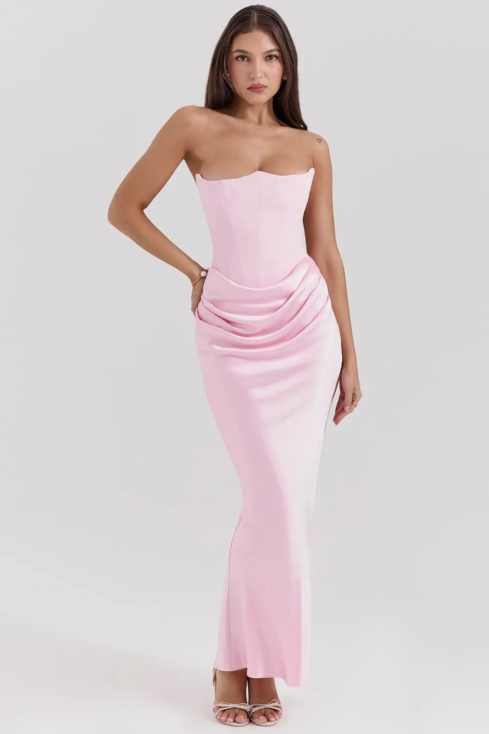 A sleek strapless pink satin long dress sexy fashion bandeau mermaid gown with a fitted bodice and draped waistline.