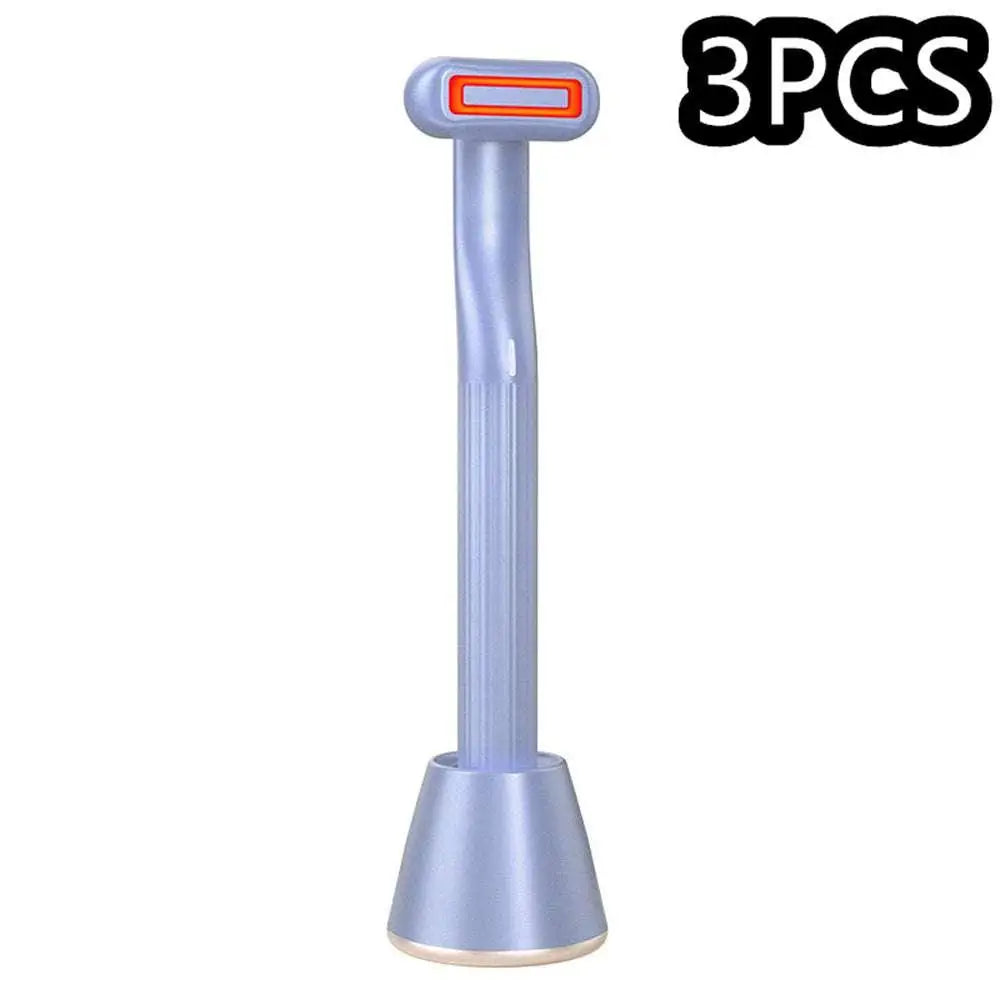 Light blue plastic rotary eye massage handpiece with orange-accented head and ribbed handle offering therapeutic warmth