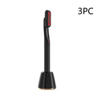 Black rotary eye massage wand with red illuminated display and therapeutic warmth in a matching black charging base