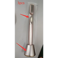 Silver-toned metal rotary eye massage key fob with sleek cylindrical body and textured grip for therapeutic warmth use