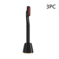 Black rotary eye massage wand with therapeutic warmth and red illuminated display standing in black charging base