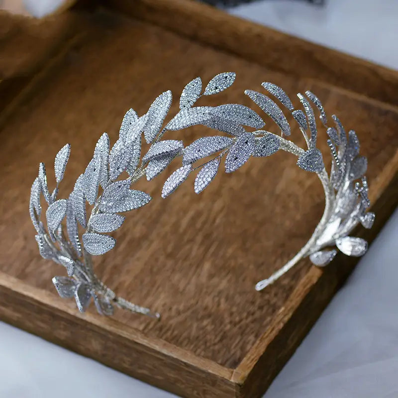 Silver leaf zircon alloy hair band featuring an alloy hair band design adorned with sparkling artificial zircon alloy crystals.