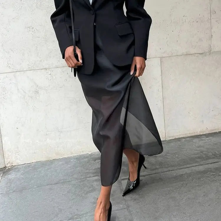black satin midi slit sheath skirt with sheer overlay and asymmetrical hemline featuring a high waist slit design