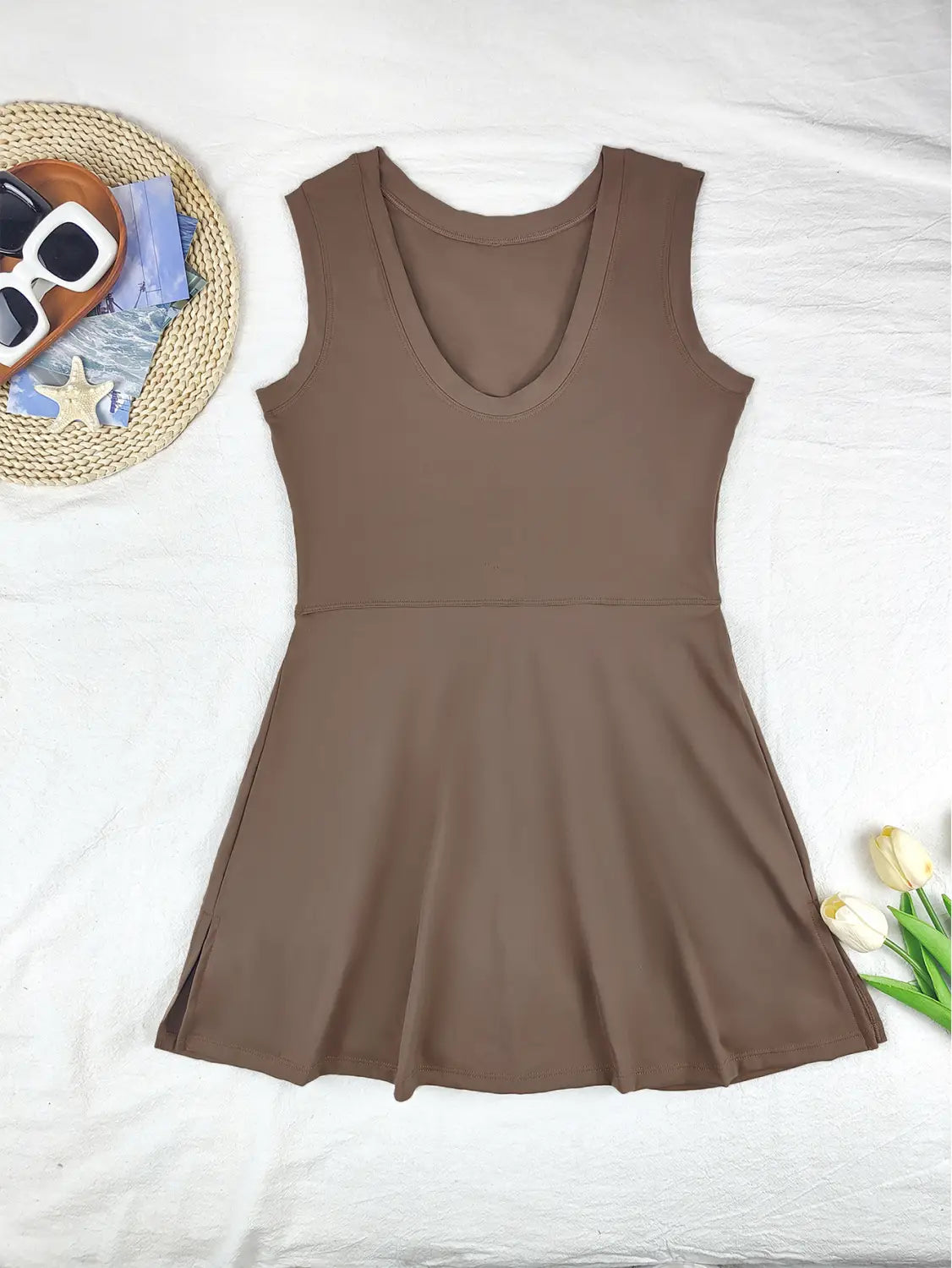 A sleek solid brown sleeveless skirt sport dress with a flattering v-neckline and flared design, ideal as a yoga tennis skirt.