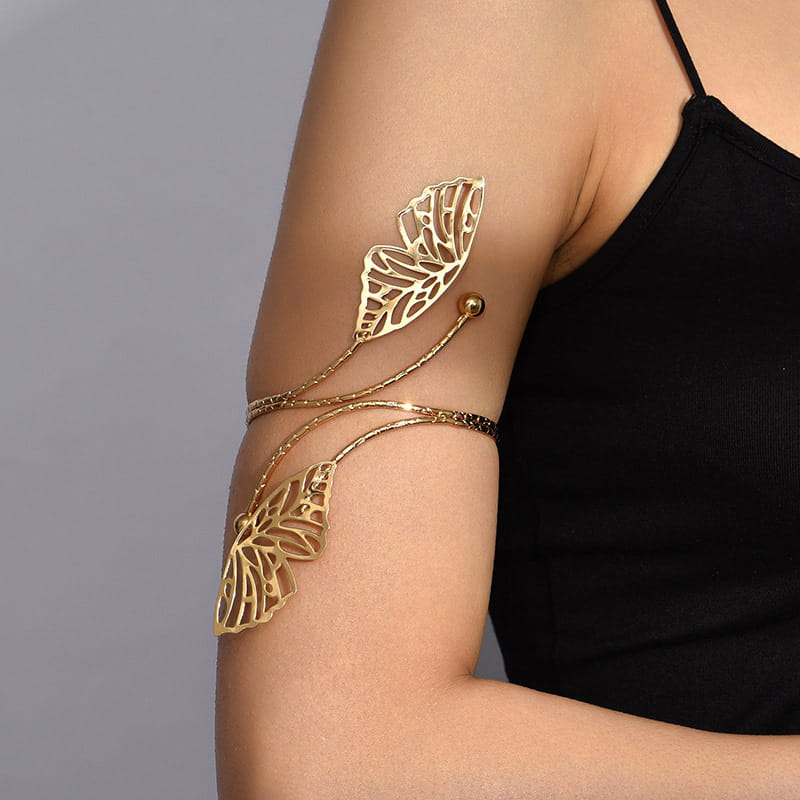 gold butterfly arm cuff featuring intricate cut-out wings and a twisted chain design in a gold tone perfect for fashion personality trend and simple body trend.