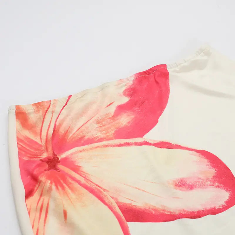 an elegant slim print floral top and skirt set featuring a vibrant coral and cream hibiscus flower print on soft, flowing lightweight fabric ideal for summer wear