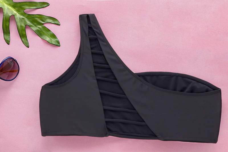 black one-shoulder bikini top with a ruched side panel made of smooth stretchy fabric featured in a high waist plus size swimsuit.