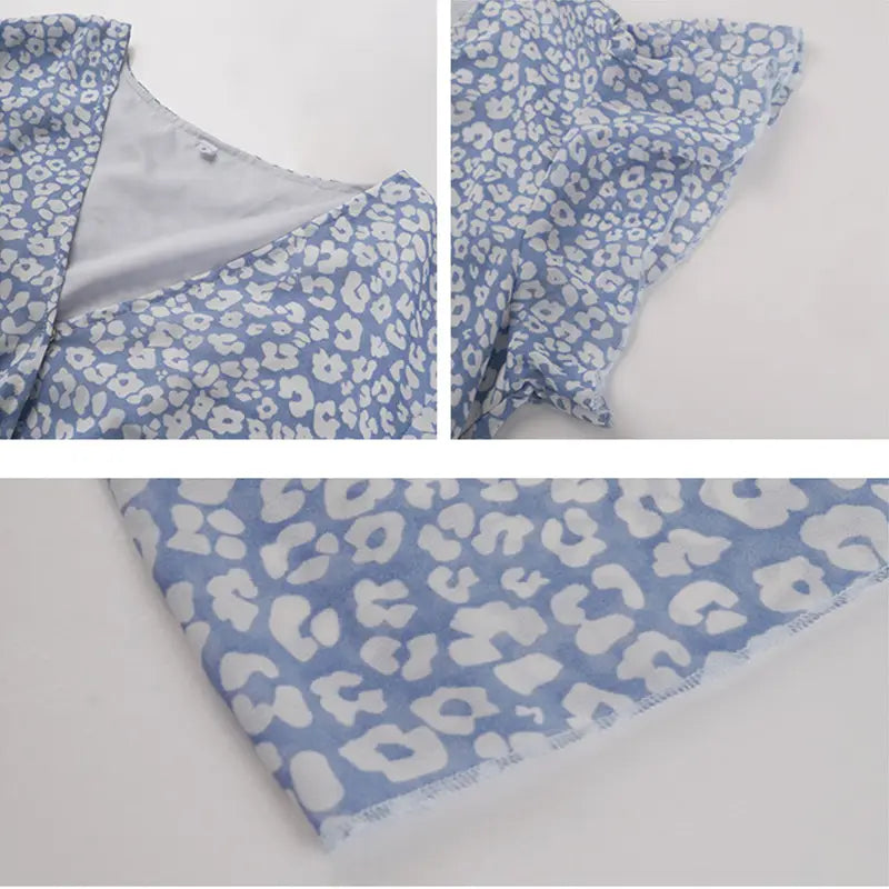A light blue summer dress with a white abstract floral pattern featuring ruffle cap sleeves and a flowing design.