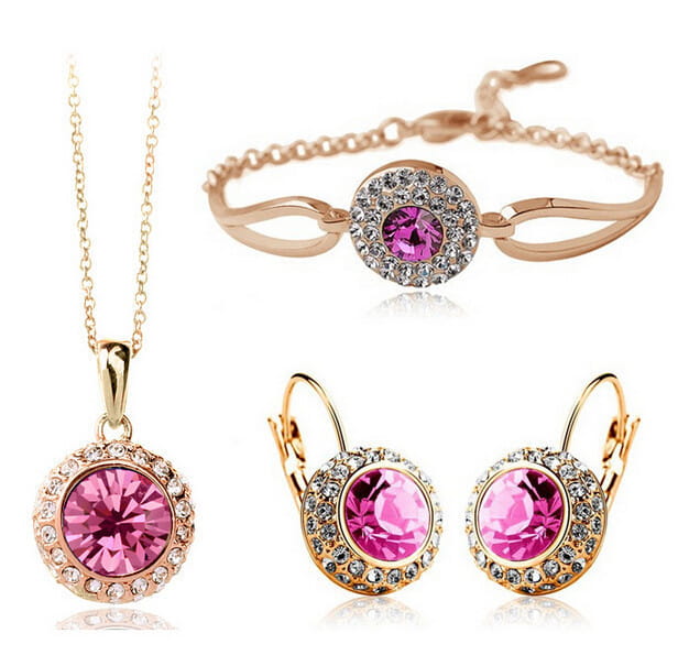 rose gold-toned korean style jewelry set featuring a central pink crystal surrounded by smaller clear crystals in silver with a fruit green accent designed for elegant wear