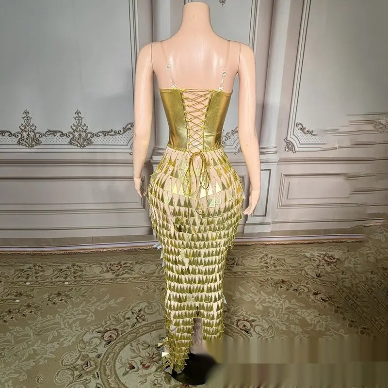 Golden bright surface bandage metallic mermaid gown featuring a shimmering gold metallic corset dress with a lace-up back and cascading triangular fringe showcasing the bright surface bandage design.