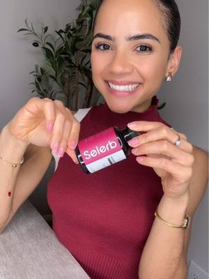 a sleek dark glass bottle with a white and pink label featuring the brand name selerb contains a clear liquid and serves as a female skin anti-aging supplement.