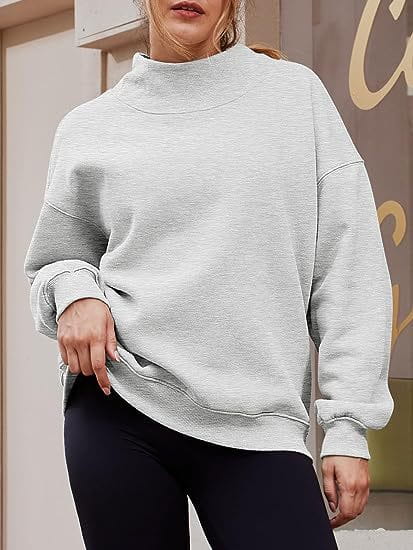 A soft heather gray oversized pullover sweatshirt solid color with a high neckline and ribbed cuffs.